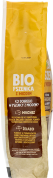 Front żółto-brązowego opakowania Bio Pszenica z Miodem, z białymi napisami o magnezie i żelazie.