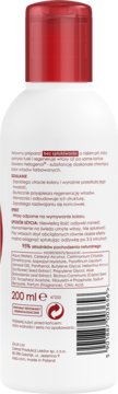 Tył białej butelki odżywki do włosów bez spłukiwania z czerwoną nakrętką, widoczny opis i kod kreskowy.