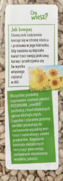 Biała etykieta Rossmann enerBiO z zielonymi polami; tekst o ekologicznych nasionach słonecznika, widok z przodu.
