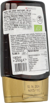 Tył ciemnobrązowej butelki z organicznym syropem daktylowym 180ml. Etykieta w j. polskim, data 02.06.2024.
