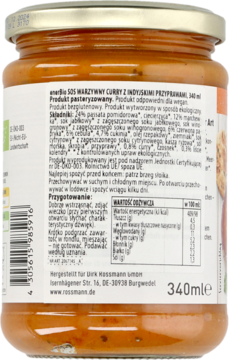 Tył szklanego słoika enerBiO Warzywny Curry 340ml z pomarańczowym sosem, widoczna biała etykieta z tekstem.