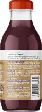 Tył szklanej butelki soku jabłkowego z czarnej porzeczki i bzu, z czerwoną nakrętką i etykietą produktu.