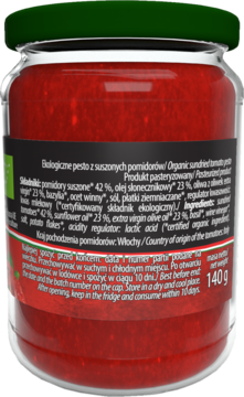Tył szklanego słoika z ekologicznym pesto z suszonych pomidorów Vitaliana, czarna etykieta ze składem.