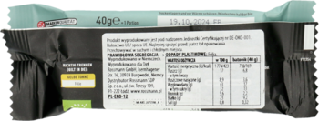 Tył czarnego opakowania batonu enerBiO 40g, z tabelą wartości odżywczych i listą składników. Widoczny zielony brzeg.