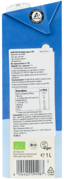 Tył niebiesko-białego kartonu Tetra Pak, organiczny napój sojowy UHT, widoczna etykieta z tabelą wartości odżywczych i kodem.