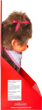 Monchhichi małpka w czerwonym pudełku, widok z boku. Pluszowa lalka z brązowym futerkiem, różową kokardą, białym śliniakiem.