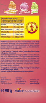 Tył różowego opakowania żelek owocowych Storck z jogurtem, 90g, wzbogaconych witaminami, z tabelą.