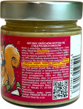 Tył szklanego słoika pasty z aksamitnego nerkowca, kokosa i żurawiny. Czerwona etykieta z wiewiórką, kod QR.