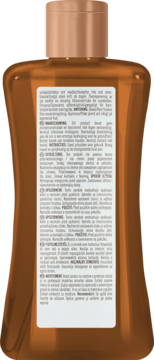 Tył bursztynowej butelki olejku do opalania Hawaiian Tropic Glowing Oil z miedzianym korkiem i etykietą.
