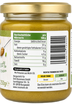 Tył szklanego słoika musu z pistacji Rossmann, widok na żółto-zieloną etykietę z tabelą wartości odżywczych.