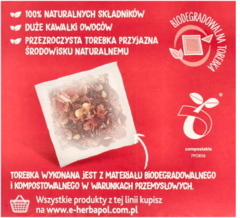 Zbliżenie na przezroczystą torebkę malinowej herbaty owocowo-ziołowej z dużymi owocami, na czerwonym tle z tekstem.