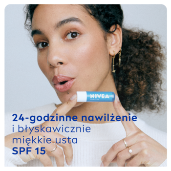Uśmiechnięta kobieta trzyma jasnoniebieską pomadkę NIVEA Hydro Care SPF 15 dla miękkich ust.