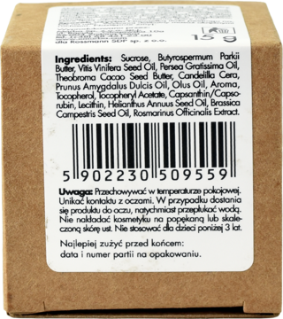 Tył brązowego opakowania cukrowego peelingu do ust, biała etykieta ze składnikami, m.in. masło shea.