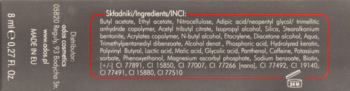 Tył opakowania lakieru Art de Lautrec Business Line, ciemny, z widoczną listą składników: kofeina, biotyna, keratyna.