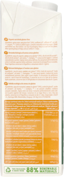 Tył białego opakowania ekologicznego napoju owsianego bez glutenu, z pomarańczowymi polami tekstu i tabelą wartości odżywczych.