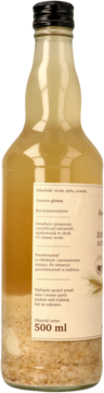Szklana butelka zakwasu na żurek, 500 ml, z beżowym płynem i osadem z grubomielonego żyta, widok z boku.
