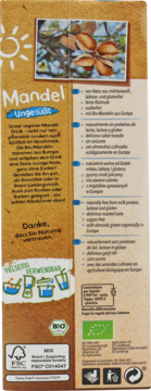 Tył jasnobrązowego opakowania bio napoju migdałowego Natumi, wolnego od laktozy, glutenu i cukru.