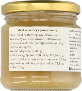Tył szklanego słoika kremowanego miodu z pomarańczą. Widoczna etykieta ze składem i wartościami odżywczymi.