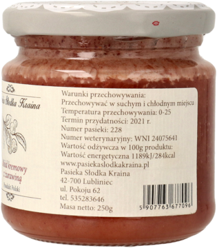 Tył szklanego słoika z kremowym miodem żurawinowym, z białą etykietą i danymi producenta Pasieka Słodka Kraina.