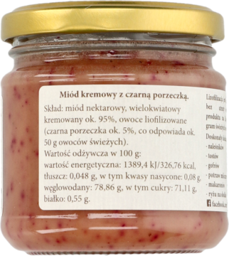 Tył szklanego słoika miodu kremowego z czarną porzeczką, widoczna etykieta ze składem i wartościami odżywczymi.
