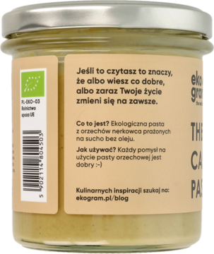Tył słoika The Real Cashew Paste. Etykieta z opisem: ekologiczna pasta z nerkowc3w, praż ona na sucho, bez oleju.