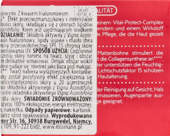 Tył czerwonego opakowania kremu Isana na dzień SPF15, z białym tekstem i składem produktu.
