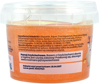 Tył przezroczystego słoika z pomarańczowym, brokatowym slime do kąpieli, z etykietą i postacią z kreskówki.