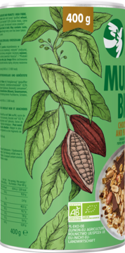 Zielona puszka organicznego musli 400g z ilustracją gałęzi kakaowca i strąków, widok z przodu.