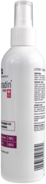 Biała butelka sprayu Nigradin, widok z boku z kodem kreskowym. Lotion do włosów przetłuszczających się i wypadających.