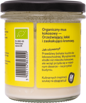 Tył szklanego słoika z organiczną pastą kokosową, żółta etykieta z opisem produktu i instrukcją użycia.