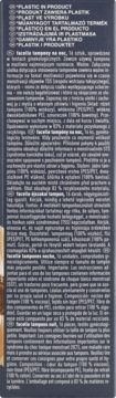 Tył ciemnego opakowania tamponów z wielojęzycznym opisem składu i ostrzeżeniem o plastiku w produkcie.