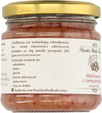 Tył szklanego słoika miodu kremowego z czarną porzeczką Pasieka Słodka Kraina, etykieta z opisem liofilizacji.