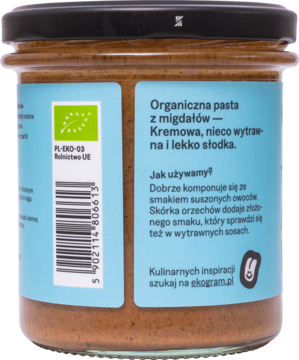 Ekologiczna pasta migdałowa, tył szklanego słoika z niebieską etykietą, opisem i certyfikatem BIO.