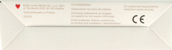 Spód jasnobeżowego opakowania puzzli z pojazdami budowlanymi, widoczne ostrzeżenia i znak CE.