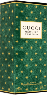 Zielone pudełko perfum Gucci Mémoire d'Une Odeur, ze złotymi gwiazdkami i kremową etykietą, przód i bok.