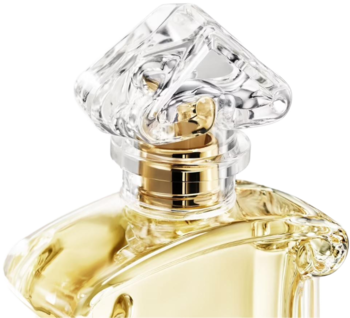 Zbliżenie na butelkę perfum Jicky Guerlain: przezroczysty, fasetowany korek i złoty kołnierz atomizera.
