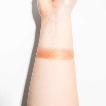 Swatch kremowo-pudrowego różu J.CAT BEAUTY Blush-Mallow 111 Baby Mochi, miedziany, błyszczący na jasnym przedramieniu.
