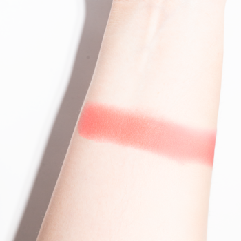 Swach różu Blush-Mallow 112 Tutti Fluffy J.CAT BEAUTY, koralowo-brzoskwiniowy odcień soft-matte na przedramieniu.