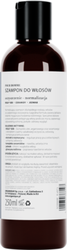 Tył brązowej butelki szamponu 250ml, czarna nakrętka. Etykieta: wzmacniająco-normalizujący z rozmarynem, cynamonem, jedwabiem.