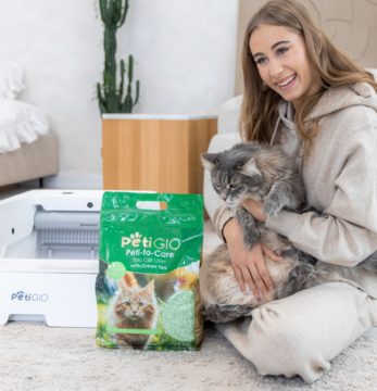 Petigio naturalny żwirek tofu z zieloną herbatą, zielona torba, kobieta z kotem, obok biała kuweta.