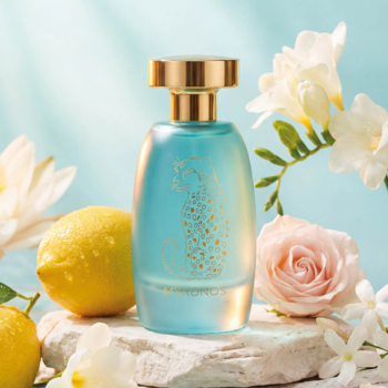 Mrożona turkusowa butelka męskich perfum Mykonos Dreamscape ze złotym leopardem, obok cytryn i kwiatów.