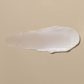 ARTDECO Brow Lift Lamination: biały, kremowy ślad żelu do brwi na beżowym tle, ukazujący jego konsystencję.