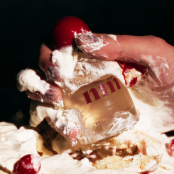 Butelka Milky Mane 002 Cherry Crush perfum do włosów i ciała, dłoń w kremie, czerwone wisienki.