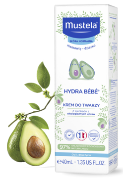 Mustela Hydra Bébé nawilżający krem do twarzy, biała butelka z zieloną gałązką awokado obok.