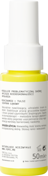 Tył żółtej butelki sprayu Skin Progress 50ml, z informacjami o niacynamidzie i tulsi na etykiecie.