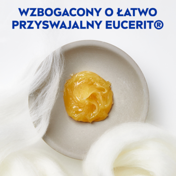NIVEA Creme, zbliżenie na krem uniwersalny z Eucerit w szarej miseczce, obok białe włókna wełny.