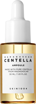 Złocista ampułka Skin1004 Madagascar Centella w szklanej butelce z białą pipetą, widok frontalny.