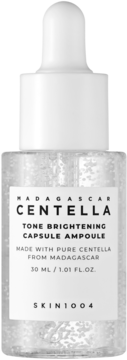 SKIN1004 Centella Tone Brightening Ampoule w butelce z kapsułkami i białą pipetą, widok z przodu.