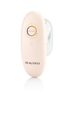 Beautifly EMS&Lipo Massager w jasnobeżowej, owalnej obudowie, z przyciskiem Release i przezroczystą końcówką.