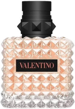 Valentino Donna Born In Roma Coral Fantasy: fasetowana butelka perfum z różowym płynem i czarnym korkiem.